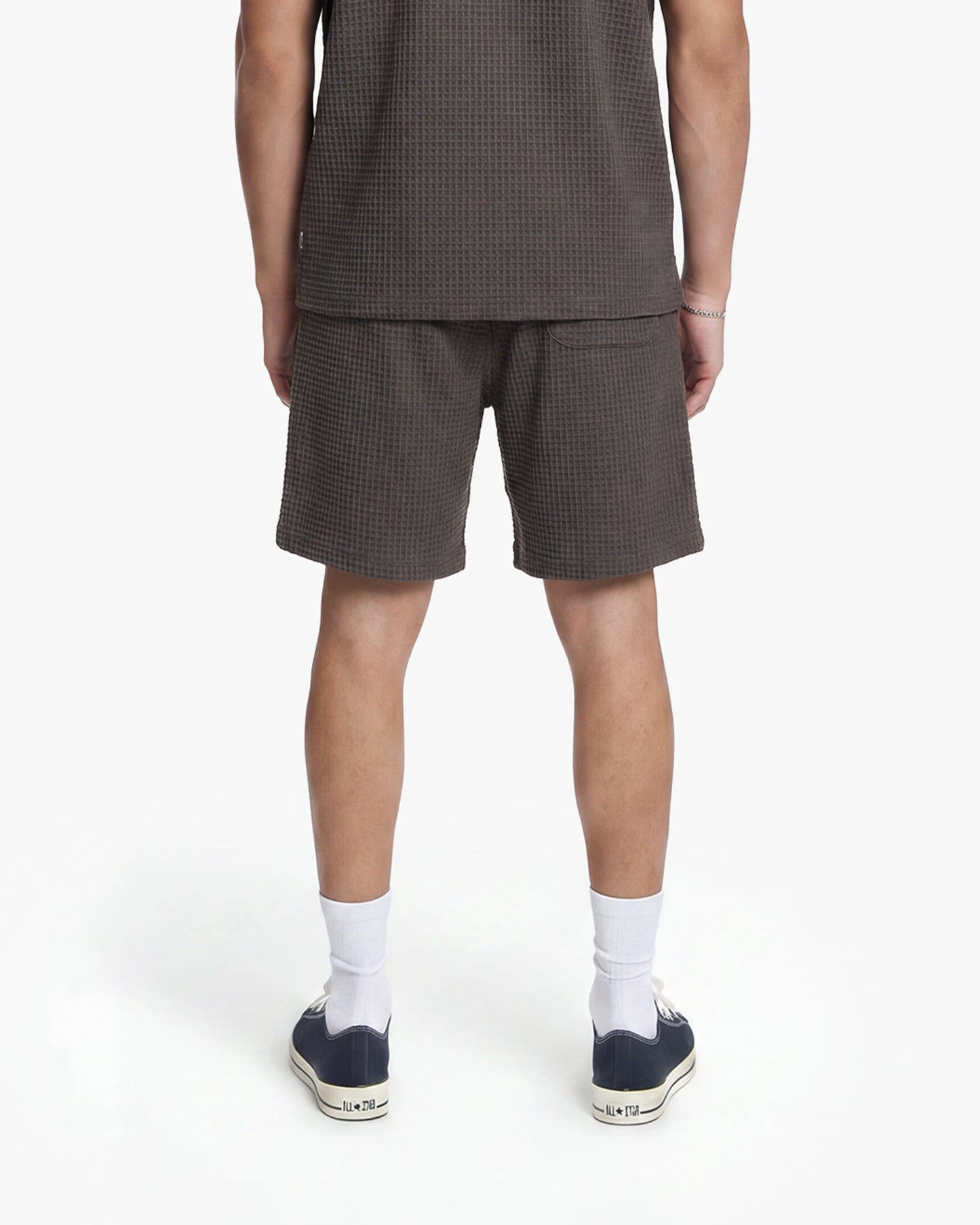 Washed brown waffle knit shorts with drawstring waist, paired with matching top and sneakers.