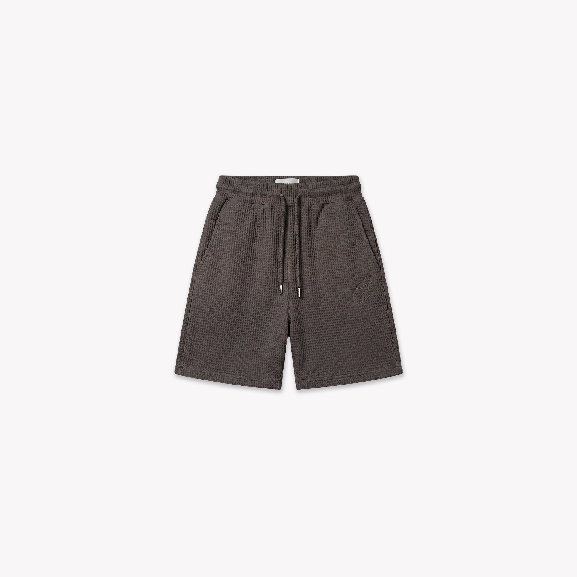 Washed brown waffle knit shorts with drawstring waist, side pockets, and subtle logo detail.