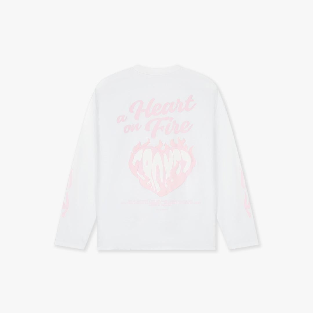 White longsleeve shirt with "a Heart on Fire" text and pink flaming heart graphic on back.