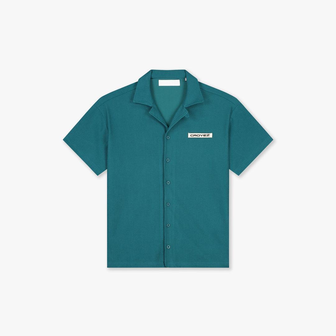Dark teal Croyez plisse short-sleeve shirt with a relaxed fit, open collar, and front buttons.